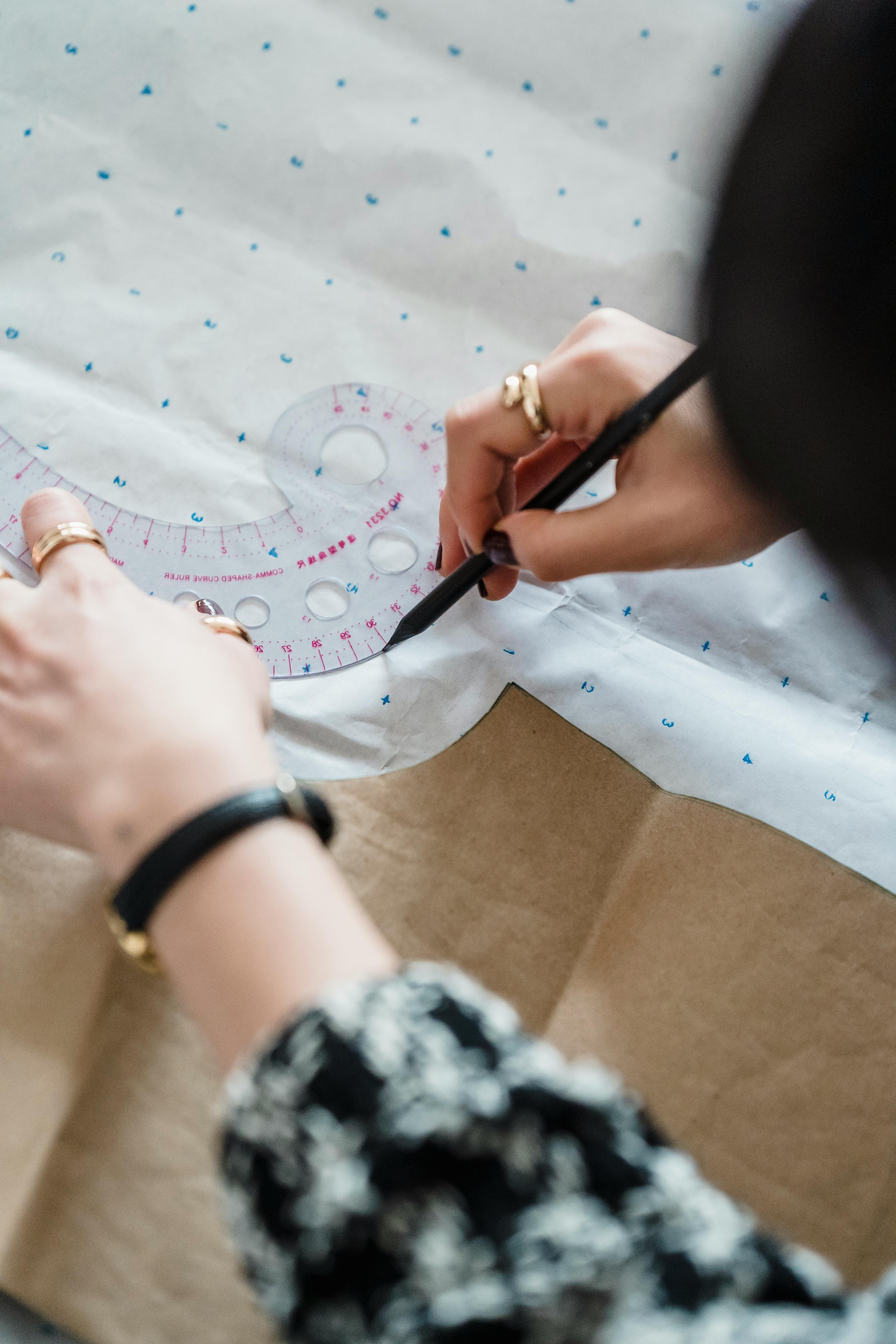 Designer working on pattern making with precision tools